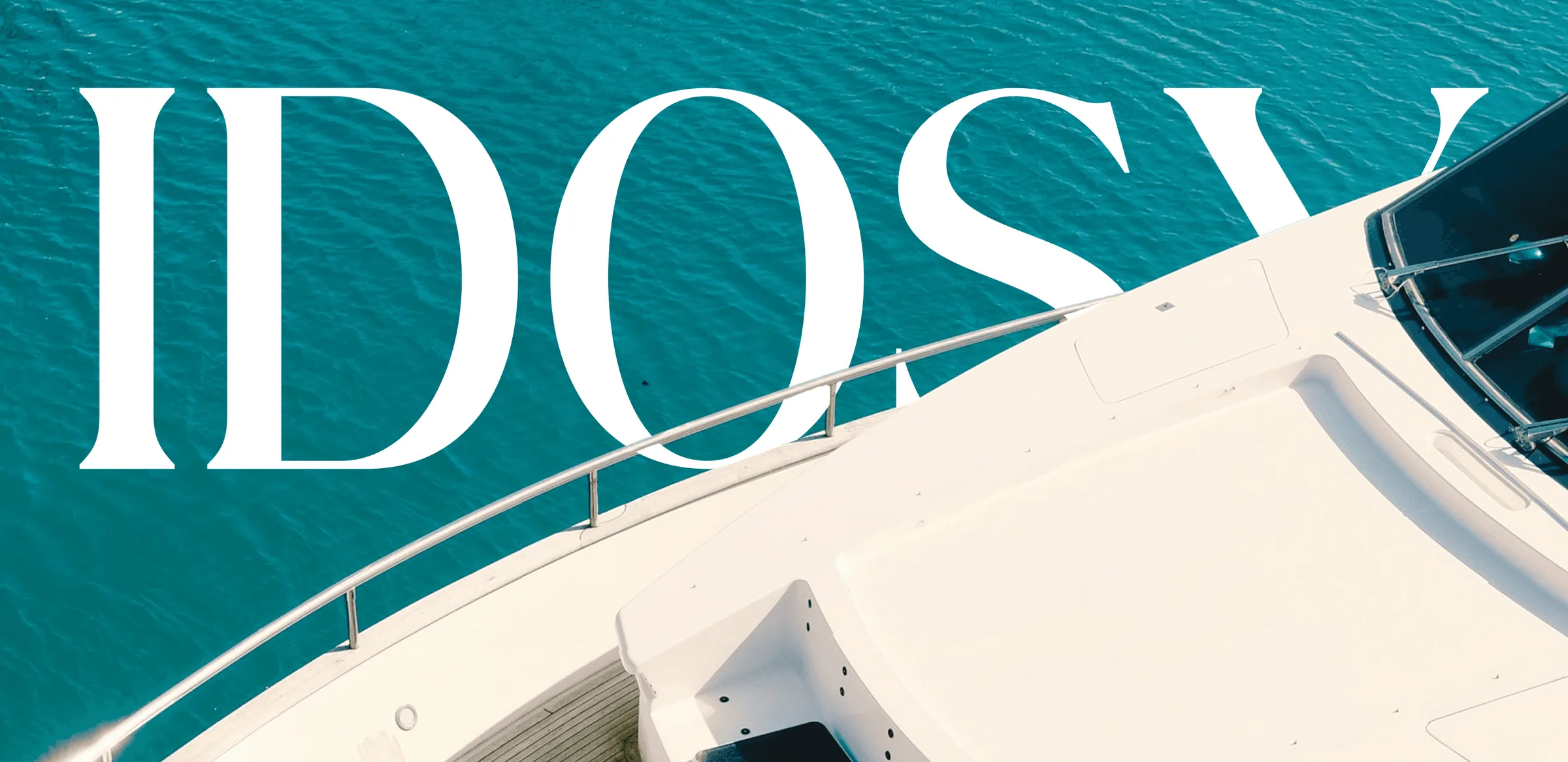 IDOSY wordmark in large white serif letters over the bow of a superyacht on turquoise water