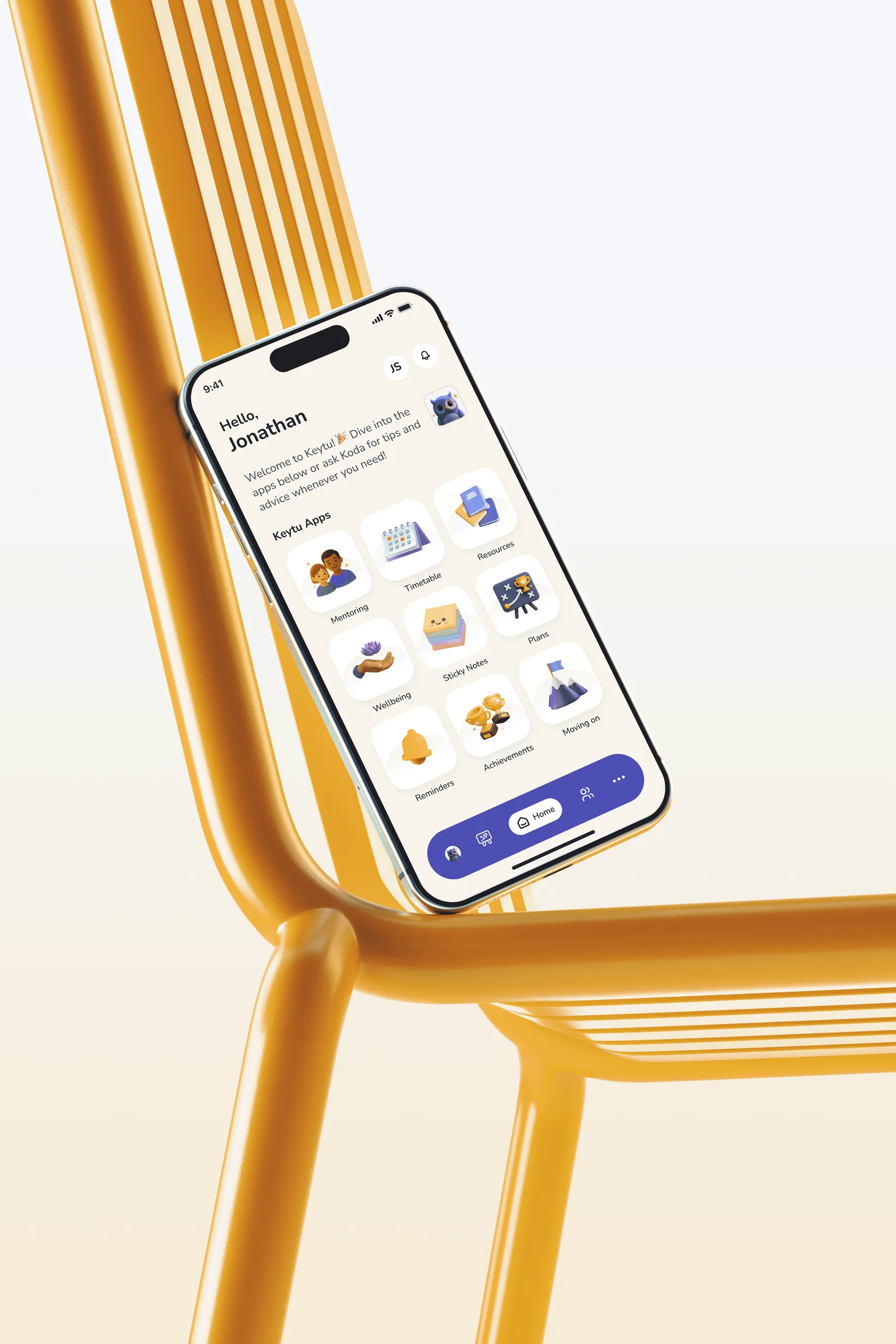Phone resting on a yellow chair, showing the KeyTu home screen with illustrated feature tiles